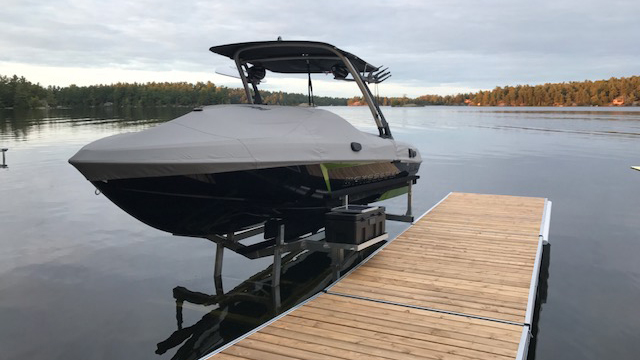 Boat docked on a boat lift over water