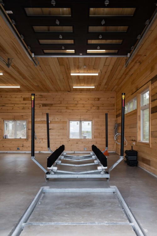 Metal railway in concrete inside a wooden boathouse