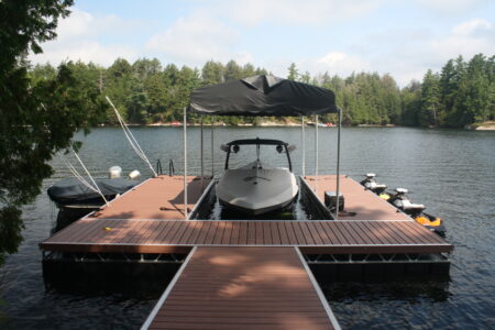 Floating dock with hydraulic boat lift and roof system