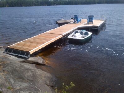 Floating dock with ramp and custom shore base plate