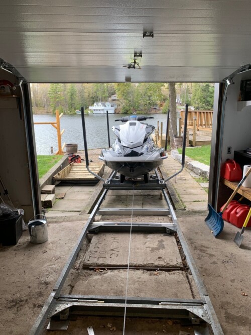 Sea-Doo on a metal carriage moving into a boathouse