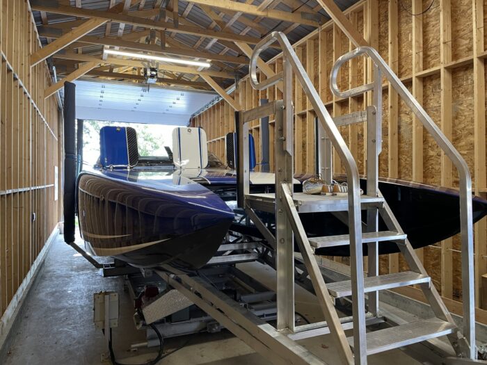 Large watercraft docked on a metal railway in a wooden enclosure