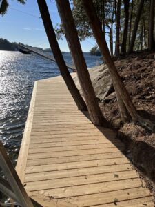 Wooden shoreline dock next to water