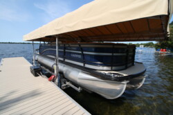 Pontoon docked on a boatlift with canopy