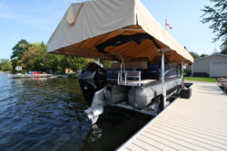 Pontoon docked on a boatlift with canopy