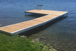 An L shaped Wave X dock with a ladder on a lake.