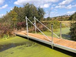 A wave X dock fully extended across a small waterway.