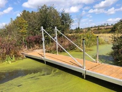 A wave X dock fully extended across a small waterway.