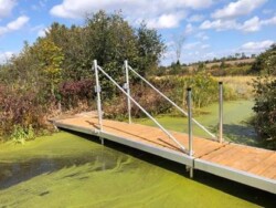 A wave X dock fully extended across a small waterway.