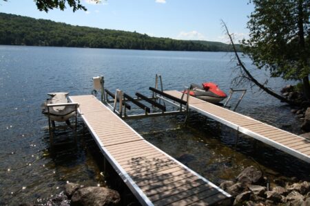 Two parallel Wave X docks with a boat lift installed between them.