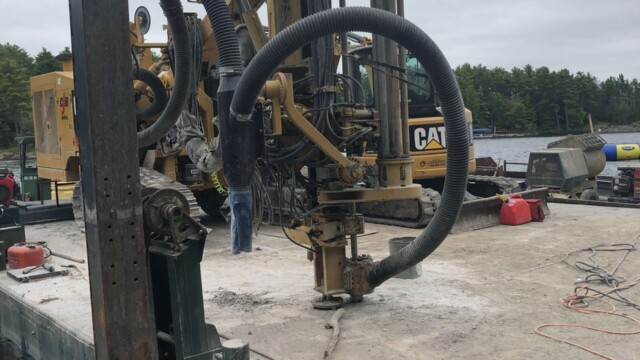 Drilling machine drilling concrete platform