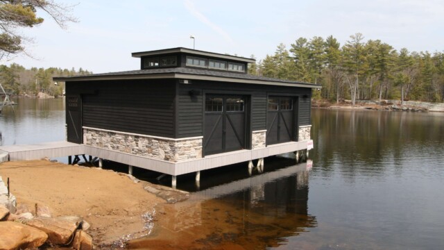 Black composite boathouse on water