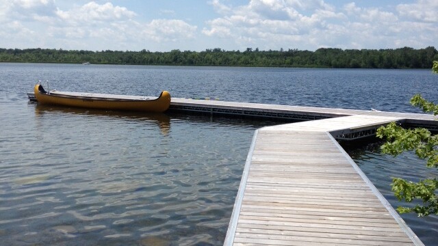 Long wooden dock with canoe