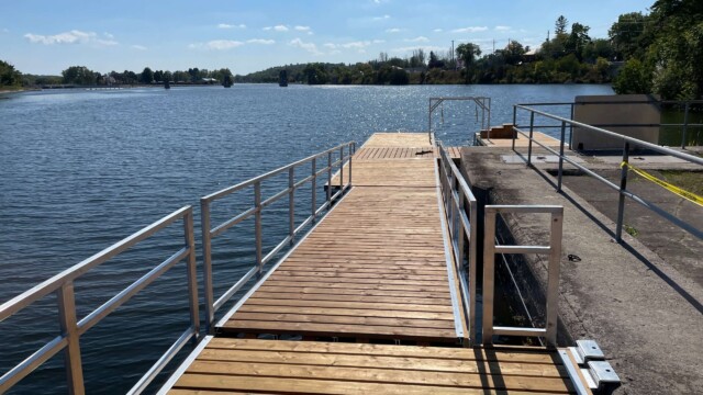 Long wooden ramp with rails on a lake