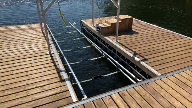 Wooden dock and metal boat lift in a lake