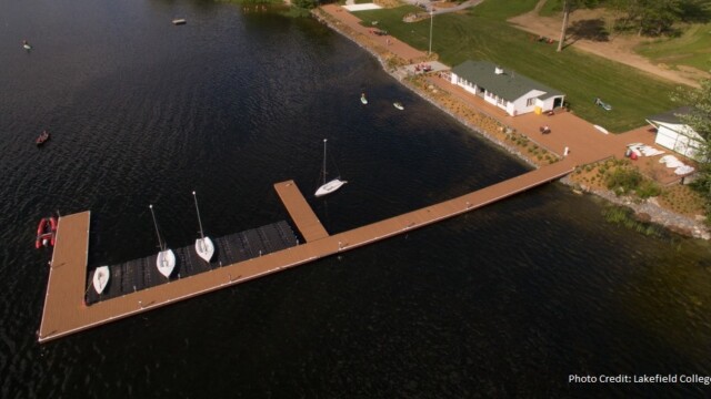Long composite dock on a lake with boats
